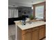 An open concept kitchen featuring stainless steel appliances and a breakfast bar overlooking the living room at 9721 Old Patina Way, Orlando, FL 32832