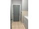 Neutral-colored laundry room featuring a gray door and a white washer at 9721 Old Patina Way, Orlando, FL 32832