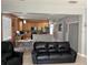 Living room with a view of the kitchen, showcasing an open concept layout, and ample natural light at 9721 Old Patina Way, Orlando, FL 32832