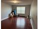 Spacious living room with hardwood floors and natural light from the large window at 9721 Old Patina Way, Orlando, FL 32832