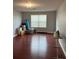 Living room with a window and laminate flooring, showing potential space at 9721 Old Patina Way, Orlando, FL 32832