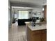 Open concept living room and kitchen area with tile flooring and a modern design at 9721 Old Patina Way, Orlando, FL 32832
