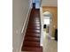 Hardwood stairs leading to the floor above with an arched entryway to the kitchen at 9721 Old Patina Way, Orlando, FL 32832