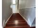 Hardwood stairs leading to the floor below, lit from the overhead light at 9721 Old Patina Way, Orlando, FL 32832