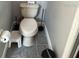 Compact toilet with cleaning supplies nearby, perfect for a small powder room or secondary bathroom at 9721 Old Patina Way, Orlando, FL 32832