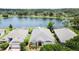 Aerial view of the property featuring views of the water, manicured lawn, and tidy landscape beds at 9824 Secret Cove Ln, Orlando, FL 32832