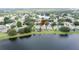 An overhead view of the neighborhood featuring a large lake and mature trees at 9824 Secret Cove Ln, Orlando, FL 32832