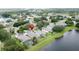 An overhead view of the neighborhood featuring a large lake and mature trees at 9824 Secret Cove Ln, Orlando, FL 32832