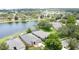 An aerial view of the neighborhood featuring the large lake and mature trees surrounding the area at 9824 Secret Cove Ln, Orlando, FL 32832