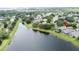 An overhead view of the neighborhood featuring a large lake and mature trees at 9824 Secret Cove Ln, Orlando, FL 32832