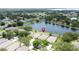 An aerial view of the neighborhood featuring a large lake surrounded by lush trees at 9824 Secret Cove Ln, Orlando, FL 32832