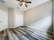 Bedroom features vinyl flooring, a ceiling fan and double door closet for optimal storage at 9824 Secret Cove Ln, Orlando, FL 32832