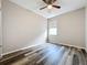 Bedroom features a ceiling fan, vinyl flooring, and a window providing natural light at 9824 Secret Cove Ln, Orlando, FL 32832
