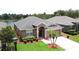 Well-maintained single Gathering home featuring a lush lawn, landscape beds, and inviting entryway at 9824 Secret Cove Ln, Orlando, FL 32832