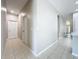 Bright hallway with tile flooring leads to the front door and other rooms in this home at 9824 Secret Cove Ln, Orlando, FL 32832