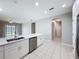 Open kitchen layout with stainless steel appliances, white cabinets, and island, plus eat-in dining area at 9824 Secret Cove Ln, Orlando, FL 32832