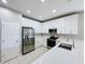 Clean modern kitchen with white cabinets and stainless steel appliances at 9824 Secret Cove Ln, Orlando, FL 32832