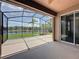 Enclosed lanai boasts beautiful views of the lake beyond the fence, offering a peaceful retreat at 9824 Secret Cove Ln, Orlando, FL 32832