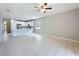 Open living area leads to modern kitchen with white cabinets and stainless appliances at 9824 Secret Cove Ln, Orlando, FL 32832