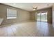 Spacious living room features tile flooring and access to the patio at 9824 Secret Cove Ln, Orlando, FL 32832