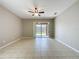 Open living room with tile flooring and sliding doors to a screened patio at 9824 Secret Cove Ln, Orlando, FL 32832