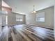 Bright living room featuring wood-look flooring and large windows at 9824 Secret Cove Ln, Orlando, FL 32832