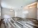 Bright living room featuring new flooring and a modern lighting fixture above at 9824 Secret Cove Ln, Orlando, FL 32832