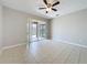 Open-concept living space features neutral paint, tile floor, and modern fan at 9824 Secret Cove Ln, Orlando, FL 32832