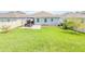 Wide angle shot of backyard featuring a green lawn, patio area, and fencing, creating an outdoor haven at 1021 Golden Dawn Loop, Minneola, FL 34715