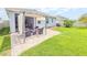 Spacious backyard includes a covered patio, green lawn, and privacy fencing; ideal for outdoor living at 1021 Golden Dawn Loop, Minneola, FL 34715