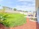 Expansive backyard features lush lawn, patio area, landscaping, and privacy fence, perfect for recreation at 1021 Golden Dawn Loop, Minneola, FL 34715