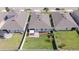 A serene backyard featuring well-maintained lawn, white fence, and a cozy patio area at 1021 Golden Dawn Loop, Minneola, FL 34715