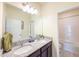 Bathroom with granite countertops, dual sinks and a shower and tub combo at 1021 Golden Dawn Loop, Minneola, FL 34715