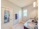 Bathroom features granite countertops, dual sinks and doorway to bedroom at 1021 Golden Dawn Loop, Minneola, FL 34715