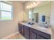 Bathroom features granite countertops, dual sinks and ample counter space at 1021 Golden Dawn Loop, Minneola, FL 34715