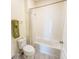 Bathroom featuring a neutral palette with combination tub and shower at 1021 Golden Dawn Loop, Minneola, FL 34715