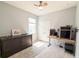 This bedroom features wood-look floors, a ceiling fan, and a large closet at 1021 Golden Dawn Loop, Minneola, FL 34715