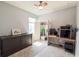 This bedroom features wood-look floors, a ceiling fan, and large closet at 1021 Golden Dawn Loop, Minneola, FL 34715