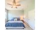 Comfortable bedroom with neutral tones, a cozy aesthetic, and modern light fixture and ceiling fan at 1021 Golden Dawn Loop, Minneola, FL 34715