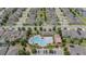 Aerial shot of community pool showcasing a large swimming area, pool house, and lounge chairs at 1021 Golden Dawn Loop, Minneola, FL 34715