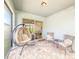 Comfortable covered patio with brick pavers, seating and relaxing egg chair at 1021 Golden Dawn Loop, Minneola, FL 34715