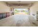 Clean garage with ample storage, work bench, and open view to the neighborhood street at 1021 Golden Dawn Loop, Minneola, FL 34715