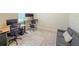 Bright office features wood-look floors, and a gray couch with throw pillow at 1021 Golden Dawn Loop, Minneola, FL 34715