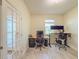Spacious office features wood-look floors, a window, and french doors at 1021 Golden Dawn Loop, Minneola, FL 34715