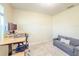 Bright office features wood-look floors, and a gray couch with throw pillow at 1021 Golden Dawn Loop, Minneola, FL 34715