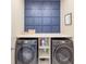 Laundry room with front loading washer and dryer and custom millwork at 1021 Golden Dawn Loop, Minneola, FL 34715