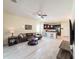 The living room flows into the kitchen, boasting dark cabinets, barstool seating, and modern stainless steel appliances at 1021 Golden Dawn Loop, Minneola, FL 34715