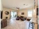 Bright living room showcasing tile floors, sliding glass doors to the lanai, comfortable seating, and an open layout at 1021 Golden Dawn Loop, Minneola, FL 34715