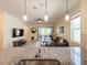 Inviting living room with open floor plan, modern furnishings, tile floors, and sliding glass doors to the outdoor living space at 1021 Golden Dawn Loop, Minneola, FL 34715