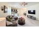 This living room showcases a modern aesthetic with an open floor plan and seamlessly connects to the dining area and kitchen at 1021 Golden Dawn Loop, Minneola, FL 34715